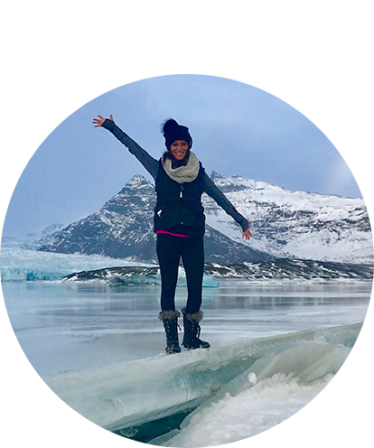 Lindsay Yonk fun photo in artic scene waving from on top of a glacier.