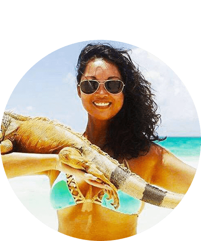 Maria Remington at beach with iguana on arm.