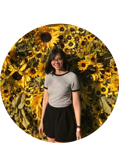 Connie Tan fun photo posing in front of a field of sunflowers on a sunny day.