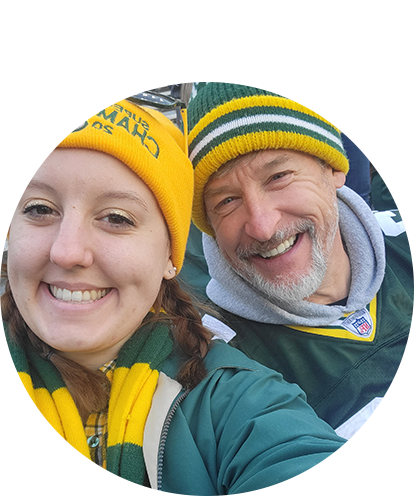 Hannah Schmuck fun photo posing with man at Green Bay Packers stadium.