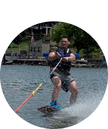 Tyle Straube wake boarding on a lake.