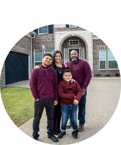 Michael Richardson posing with family in front of their home.