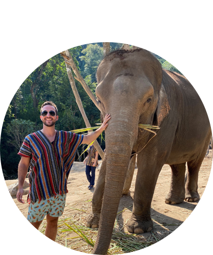 Steven Nikolidakis feeding an elephant.