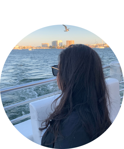 Araceli Oceguera fun photo enjoying the view on a boat over a large body of water.