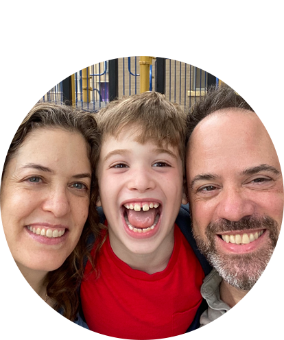 Daniel Cohen posing with young child and adult female.