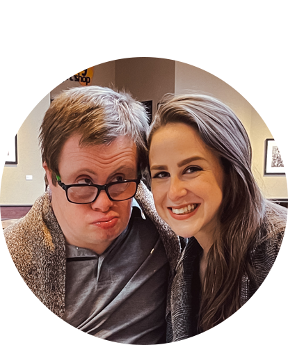 Elisabeth Klisser fun photo posing with adult male on with piano in background.