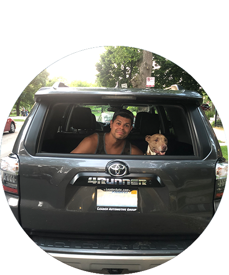 Man in back of car with dog