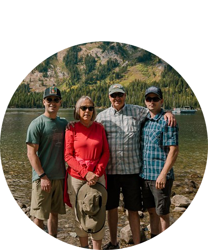 Brian Cordova fun photo (4 humans posing outside with mountain lake in background on sunny day).