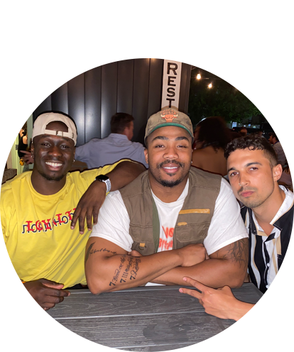 Franklin Eruo fun photo seated at a table with two other adult males.