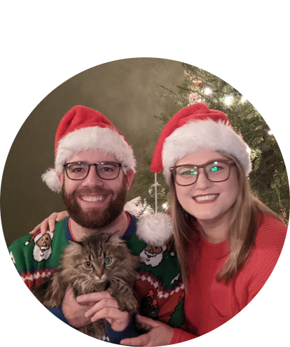 Kristen Bauler fun photo in holiday photo posing adult male and adult cat with Santa hats on.