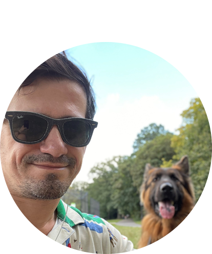 Hamid Lekic fun photo (adult male posing outside with sunglasses on and panting dog to side).