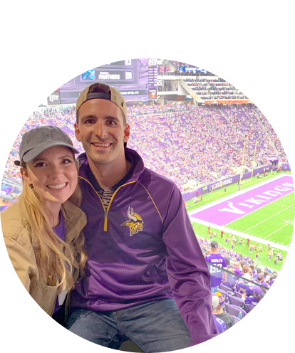 David Kolsrud fun photo (adult male and adult female posing at Vikings Stadium wearing team colors).