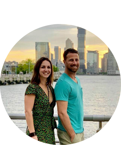 Evie Law fun photo (adult female and adult male posing outside with city skyline in background at sunset).