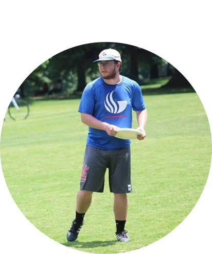 Hunter Sanders fun phot (adult male holding frisbee in grassy field on a sunny day).