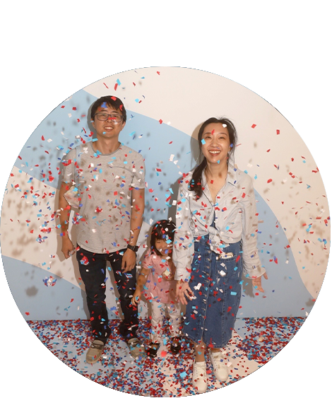 Man, wife and kid with confetti