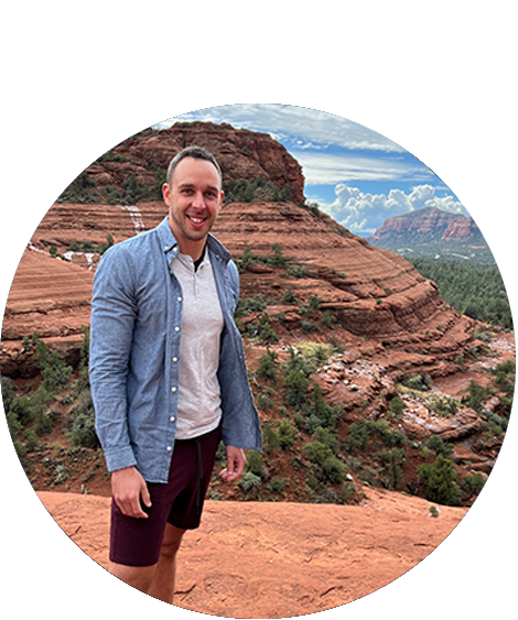 man standing by rock formation