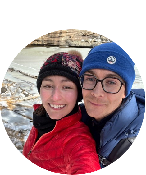 Woman and man smiling in beanies