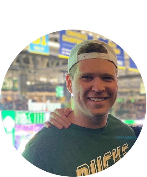 Man in green shirt smiling
